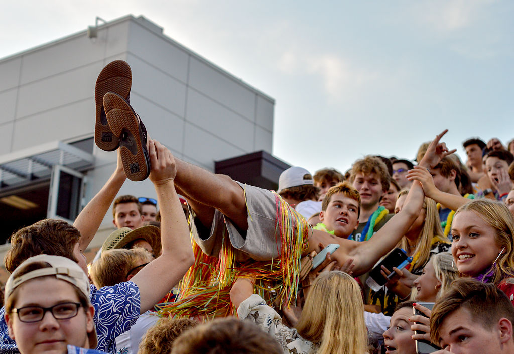 Rock Bridge senior Jack McCallister crowd surfs through a cluster of Rock Bridge fans
